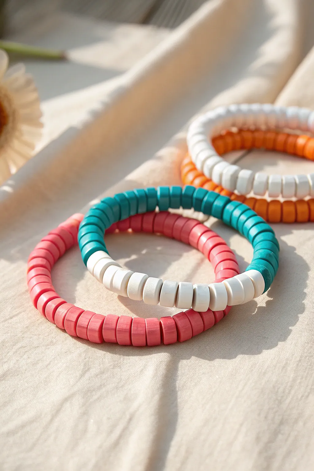 Bold color-block clay beads meet minimalist style in a preppy stack you can make at home.