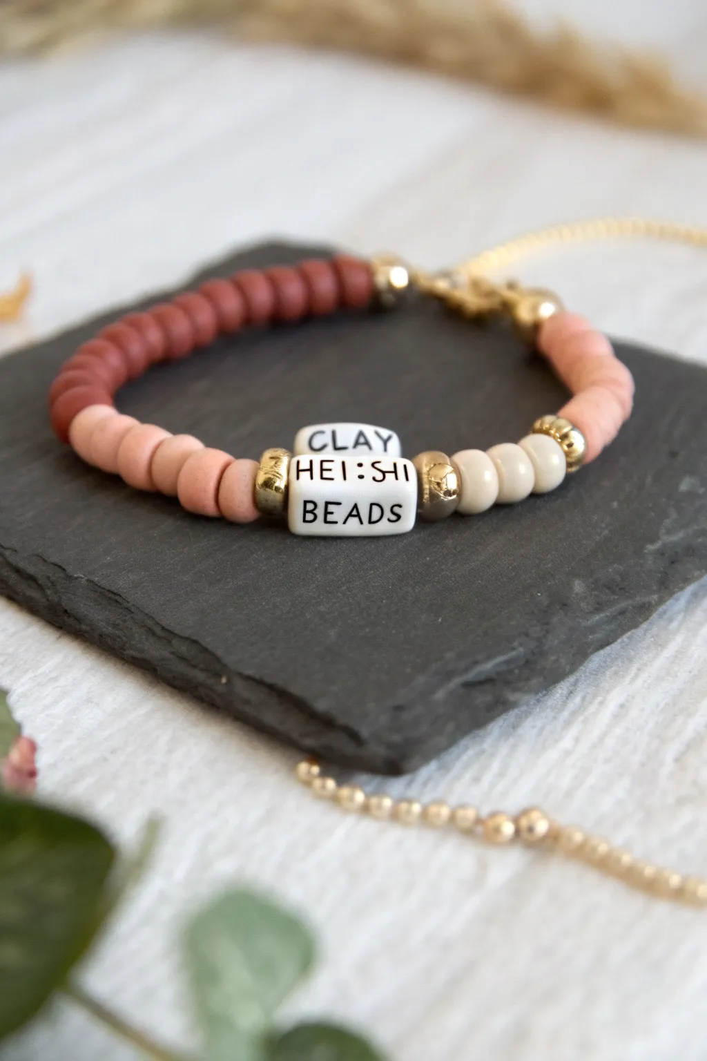 Sweet minimalist clay heishi bracelet with a centered initial detail for an easy personalized look.