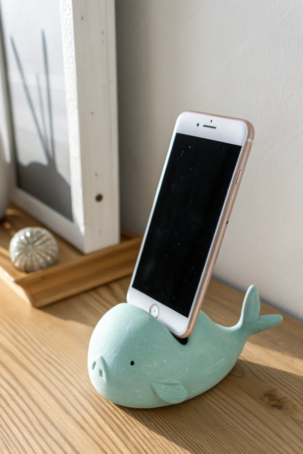 Pastel whale clay phone stand that keeps your screen upright while adding a cute handmade touch