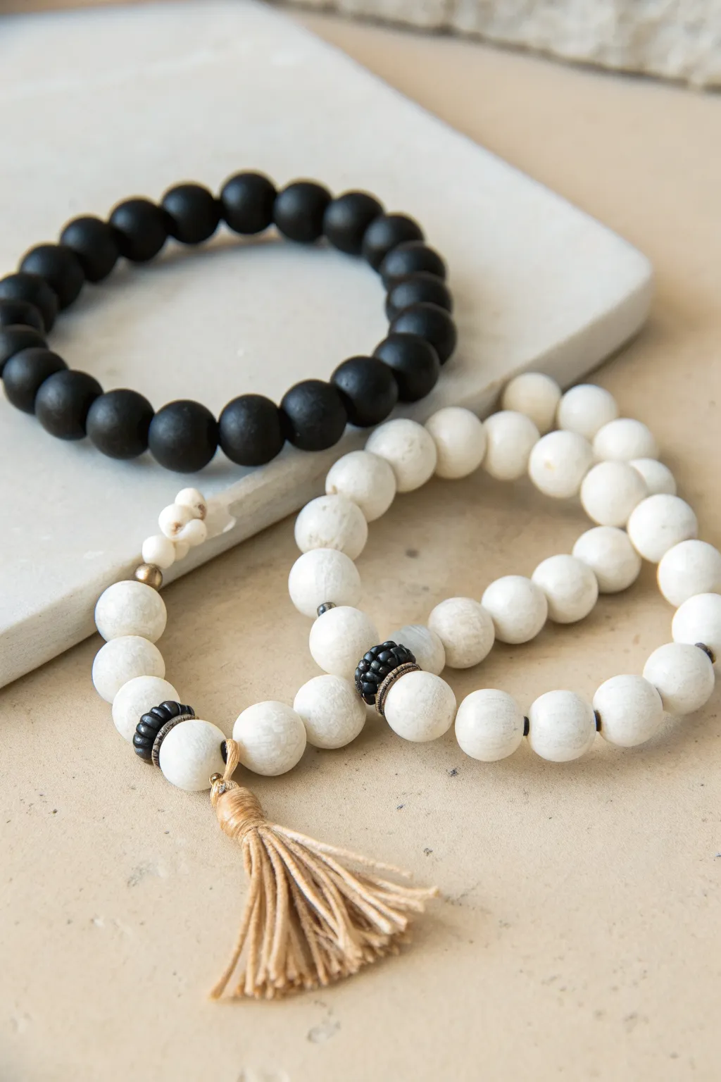 Crisp black-and-white clay bead bracelets for a modern minimalist stack with subtle boho charm.