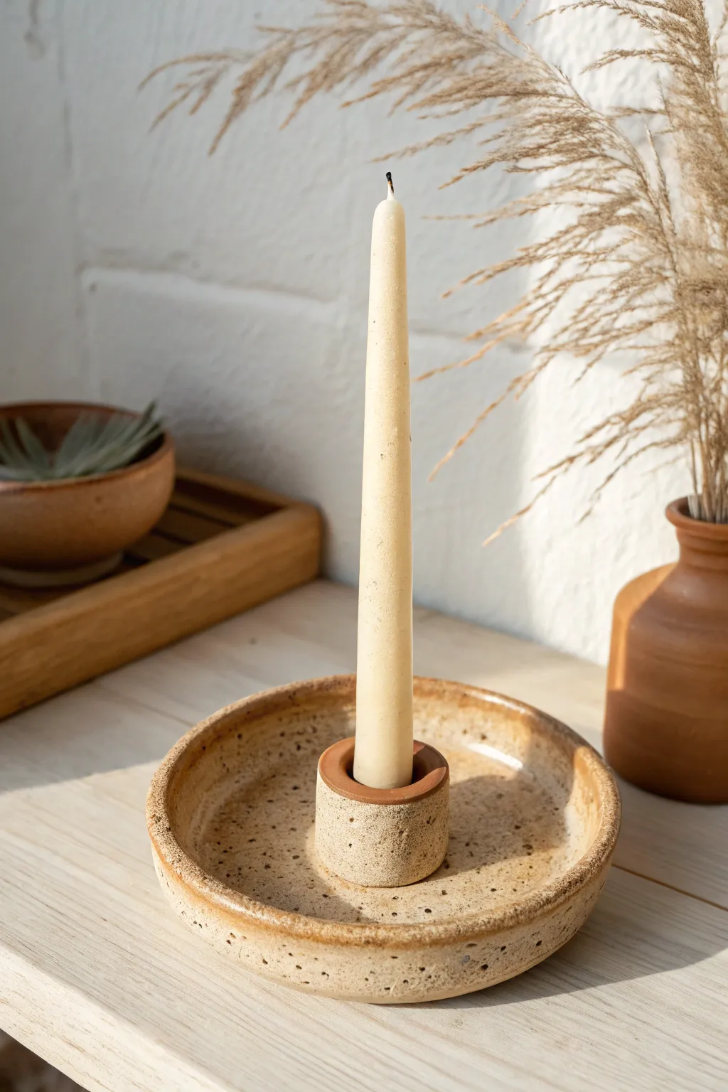 Classic DIY clay taper holder with a round base in warm neutrals for a timeless minimal look