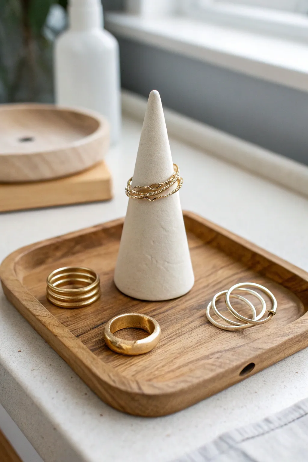 Minimal cone ring holder in satin clay, perfect for an easy adult pottery project.