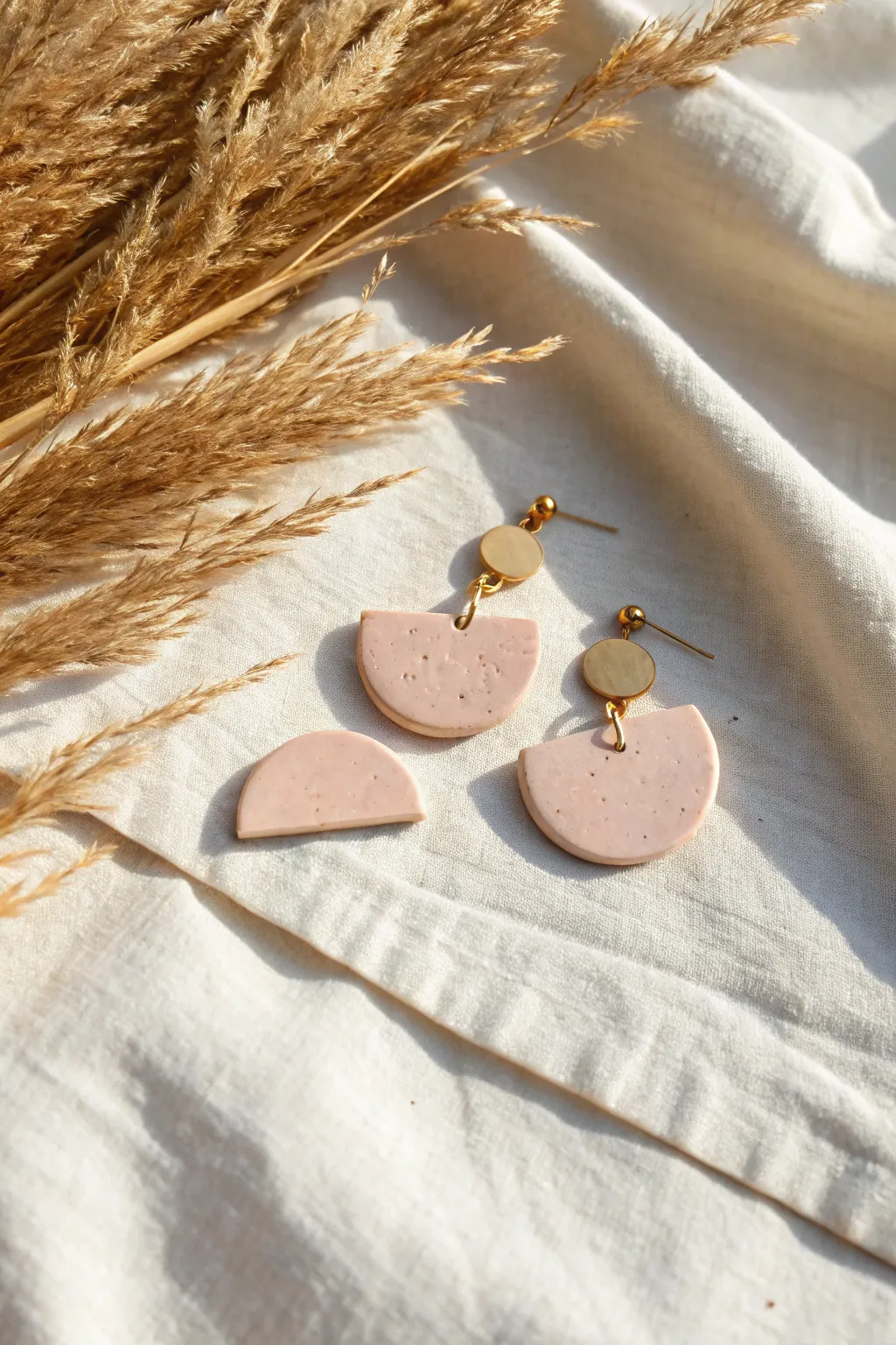 Simple half-moon polymer clay minis in soft blush tones, clean lines, satin finish, and cozy contrast.