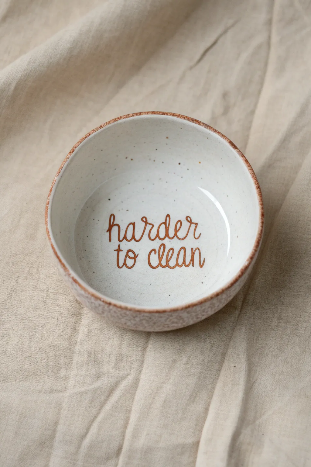 Minimalist cereal bowl with a cheeky harder to clean punchline painted on the inside.