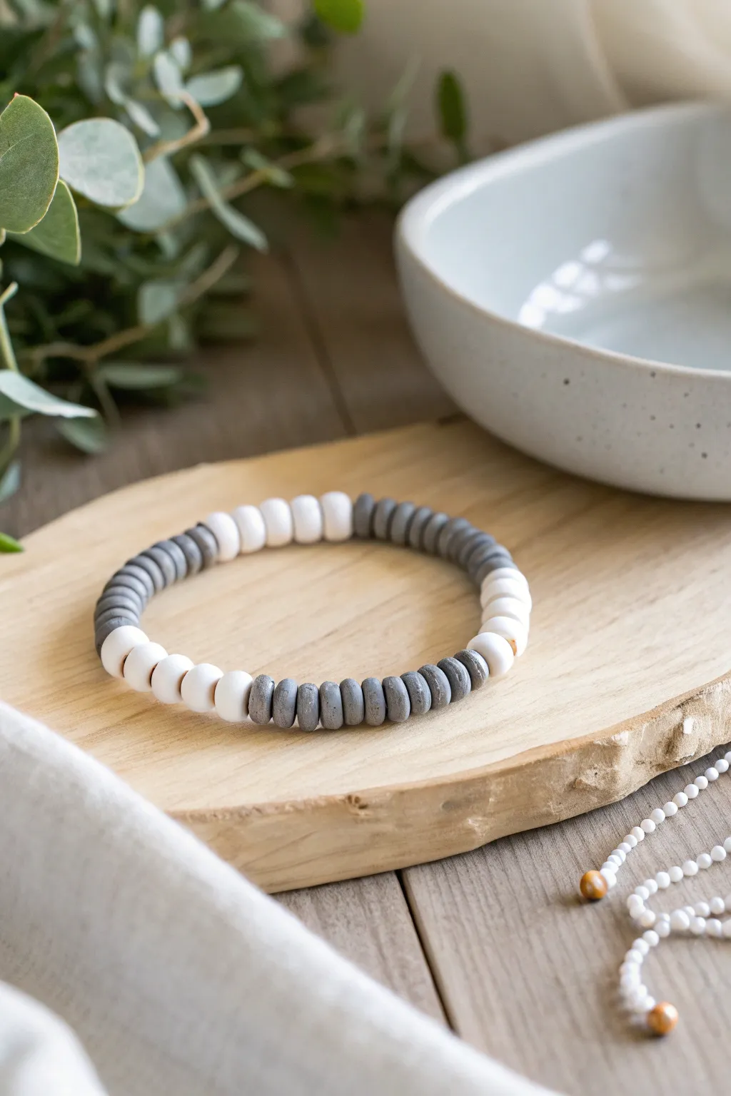 Minimal grey clay heishi and white bead bracelet for crisp, Scandinavian calm with boho warmth.