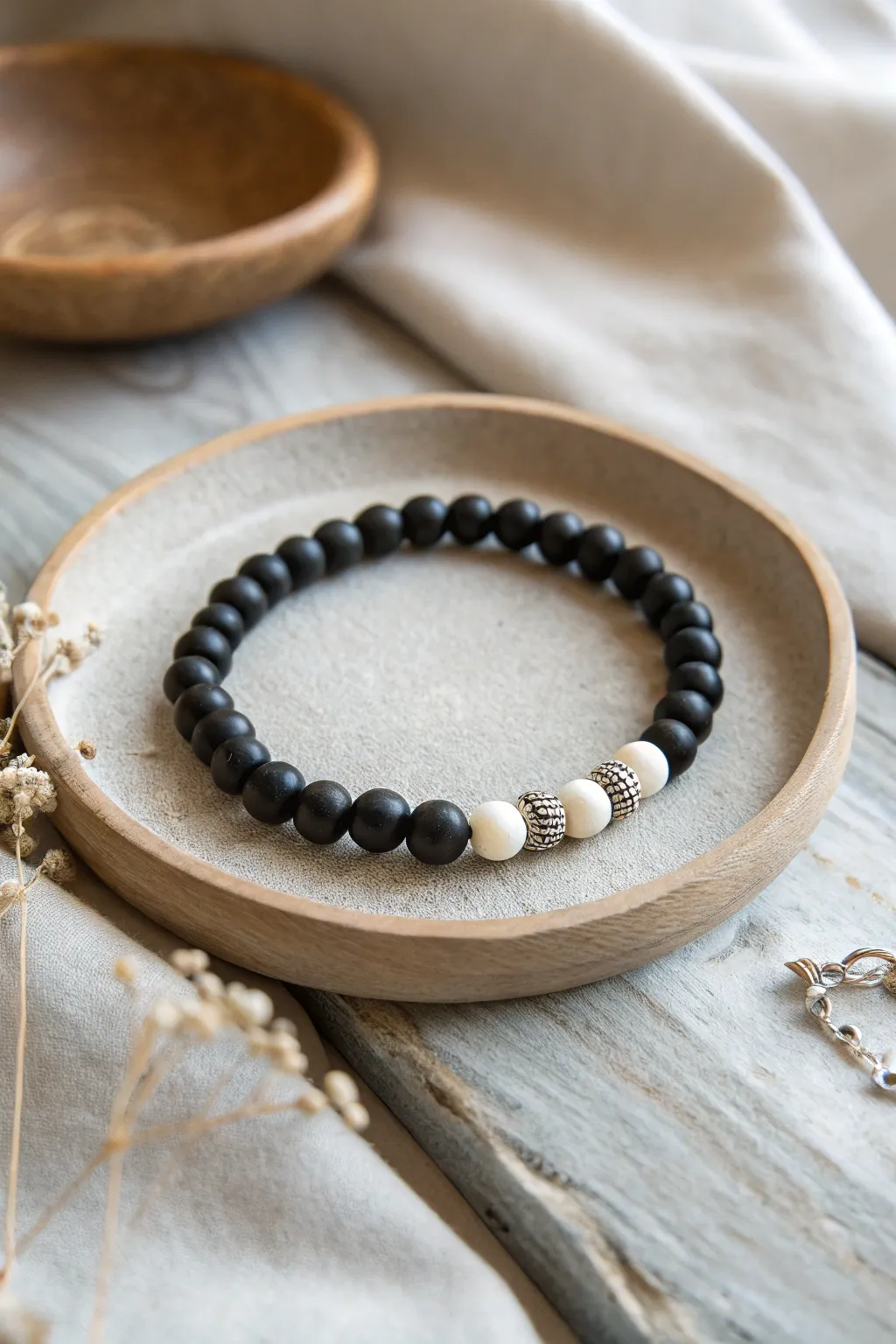 Midnight black clay bracelet with crisp ghost-white bead clusters for subtle Halloween charm.