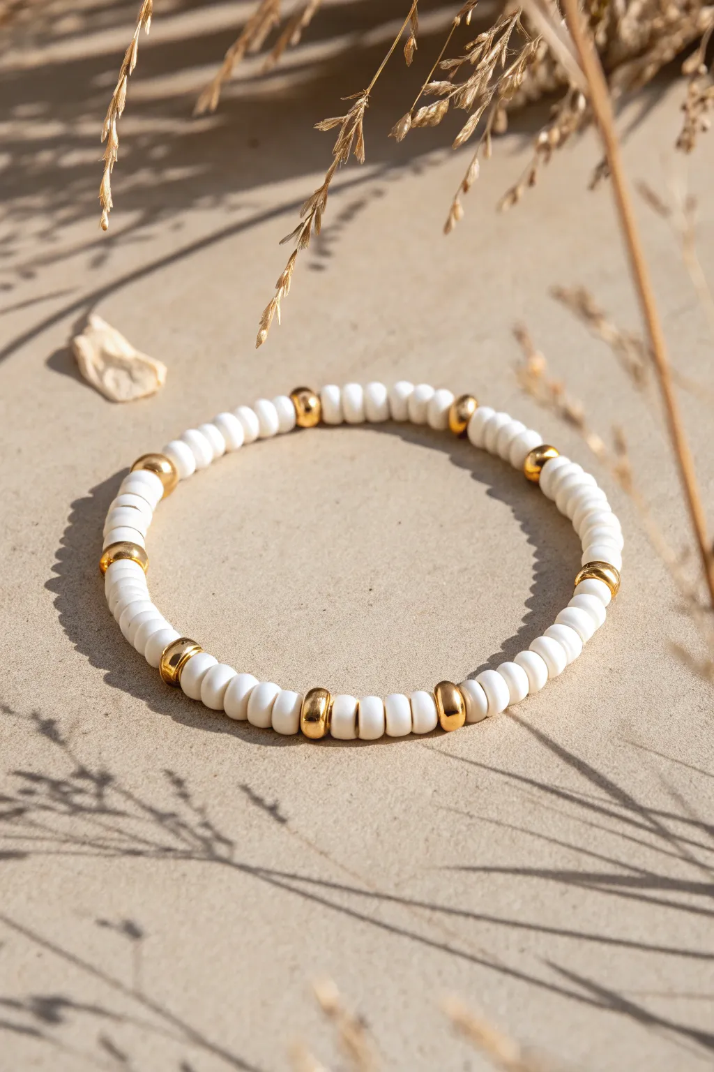 All-white heishi clay bracelet with subtle gold pops for a clean minimalist boho look.