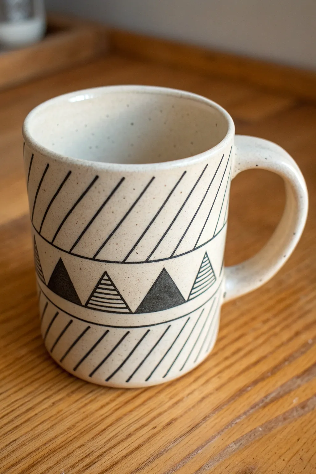 Minimal diagonal stripes and triangles in charcoal and gray for a clean, modern guy-friendly mug.