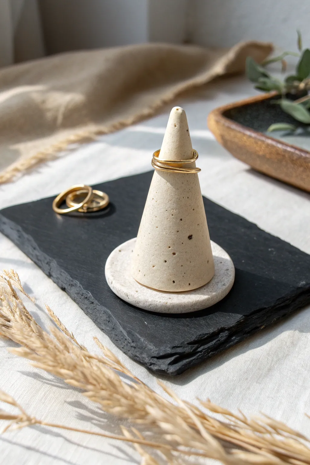 Minimal monochrome ring cone in soft sand clay, a tidy handcrafted piece for calm styling.