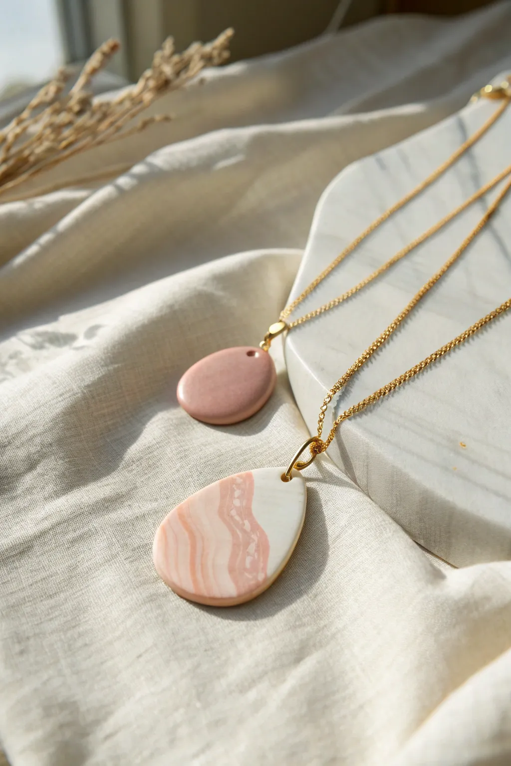 Softly marbled polymer clay pendants on a delicate chain, minimal, warm, handmade charm