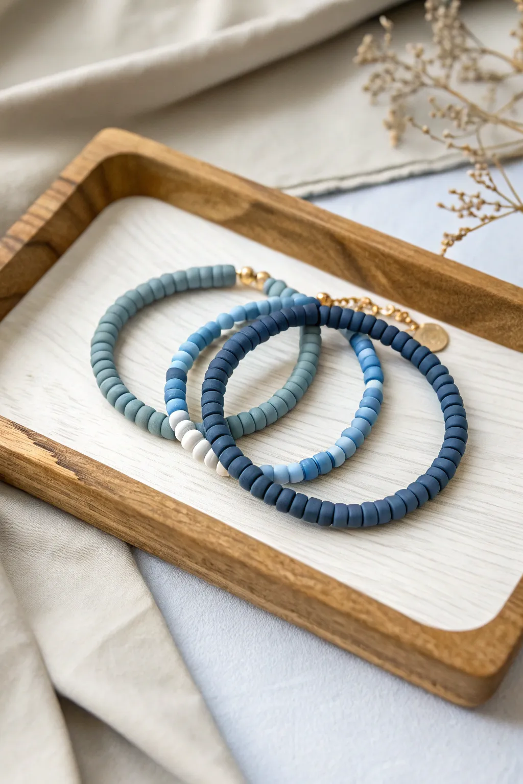 Monochrome blue heishi stacks with soft shade shifts, simple, calm, and beautifully handmade