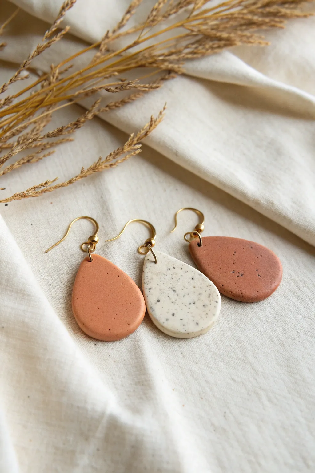 Easy teardrop polymer clay dangles in solid and speckled finishes for everyday wear.