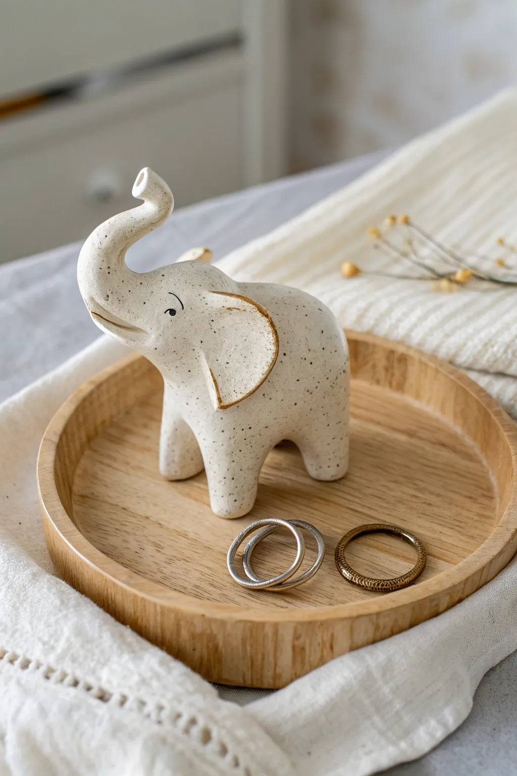 Minimal elephant sculpture holder with upturned trunk, perfect for rings and necklaces.