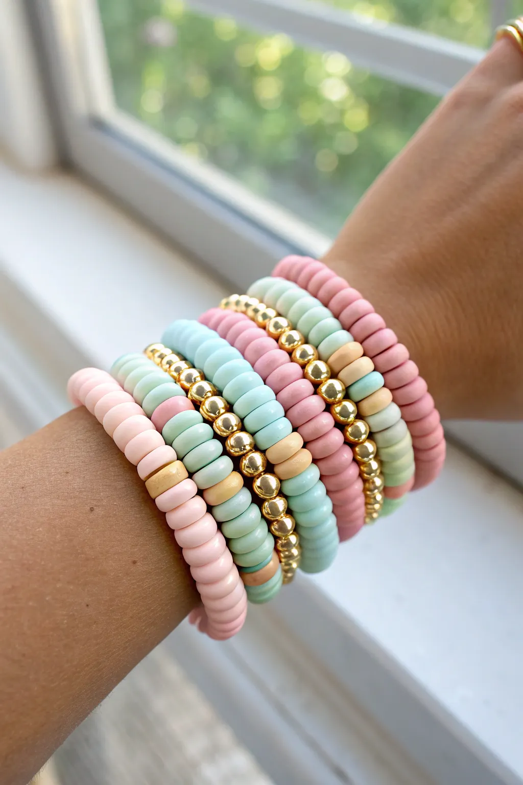 Pastel clay discs meet tiny gold spacers for a crisp, preppy stack that feels luxe and handmade.