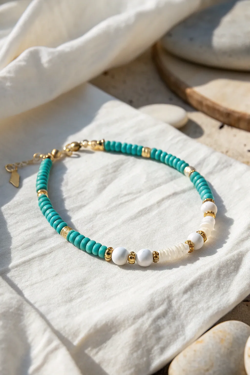 Ocean-blue heishi bracelet with crisp white breaks and tiny gold spacers for preppy polish