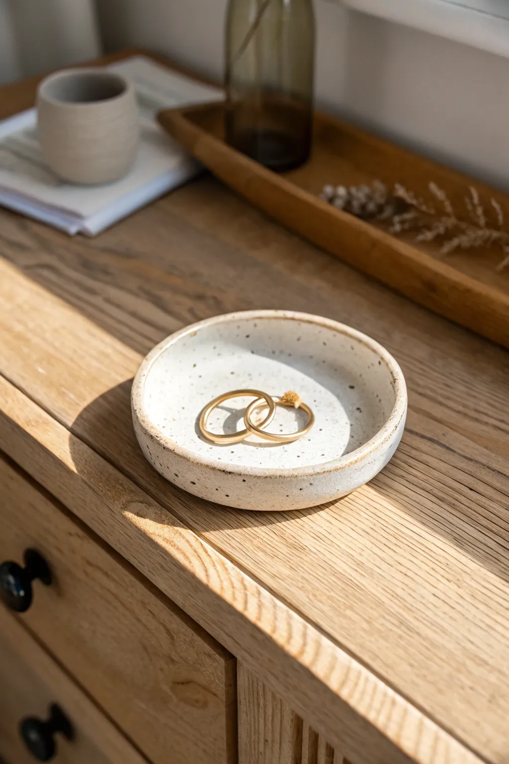 Round slab catch-all tray with a pinched rim, keeping rings and a hair clip tidy.