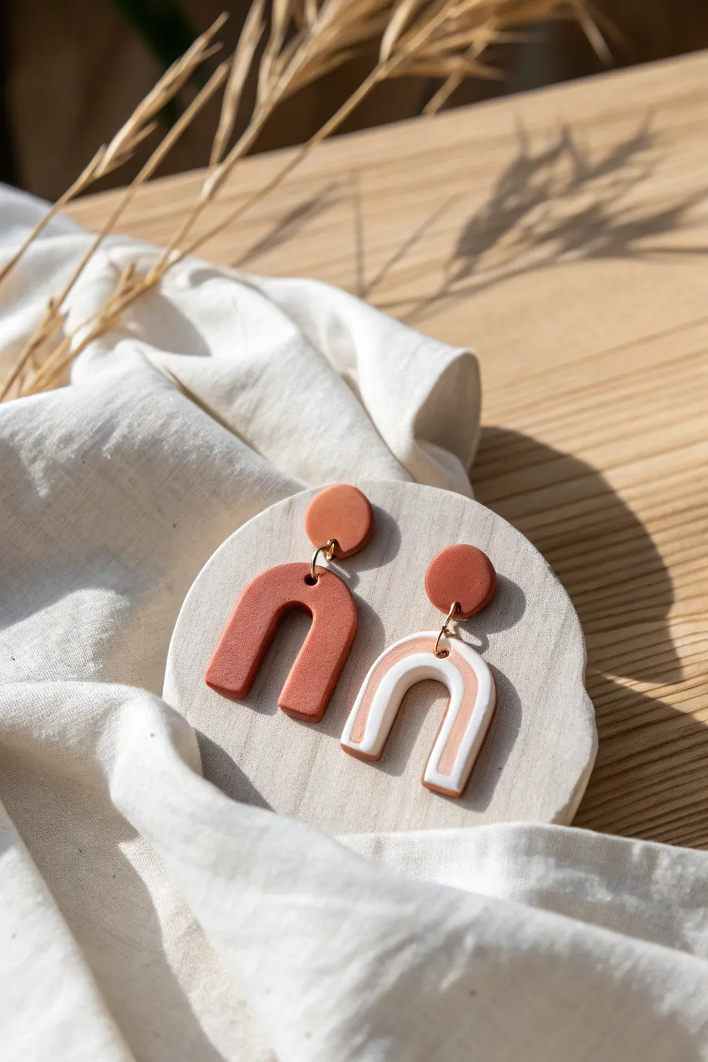 Minimal polymer clay slab earrings in soft earthy tones, styled on linen for modern boho vibes