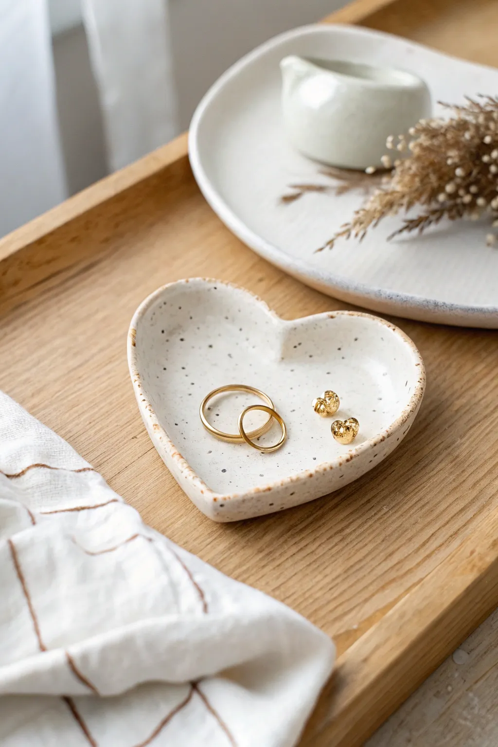 Sweet mini heart dish in matte clay, holding simple studs with cozy Scandinavian calm