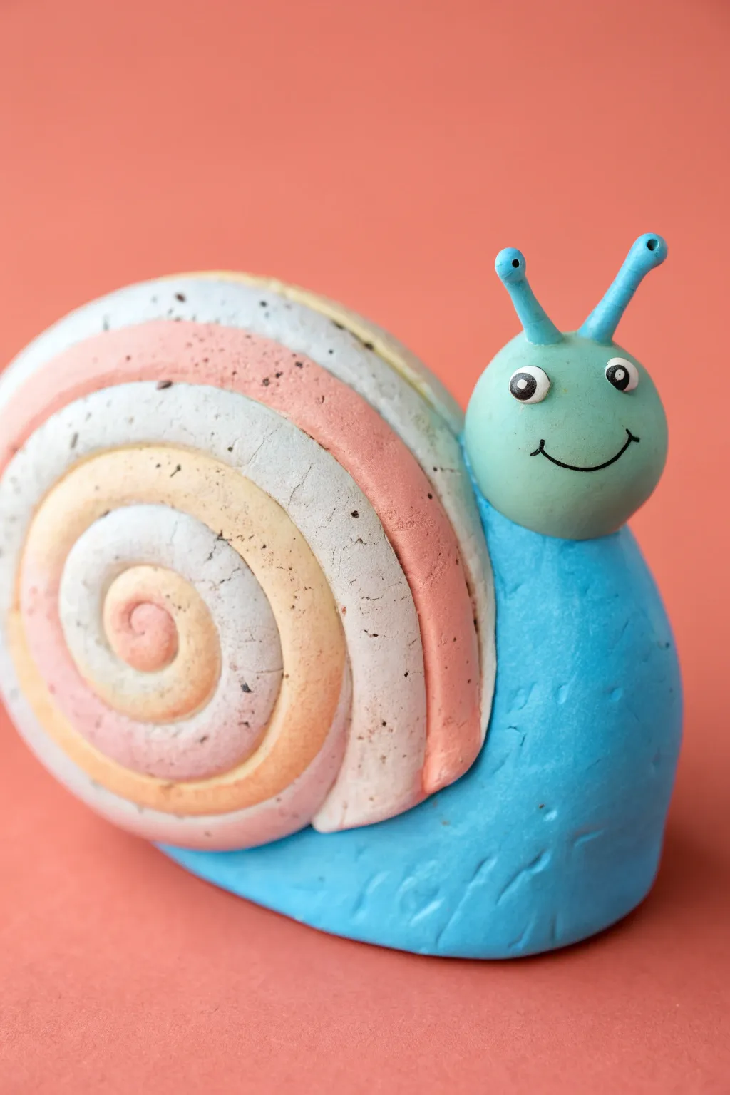 Chunky spiral snail in bright clay colors, easy kid friendly project with bold swirled shell