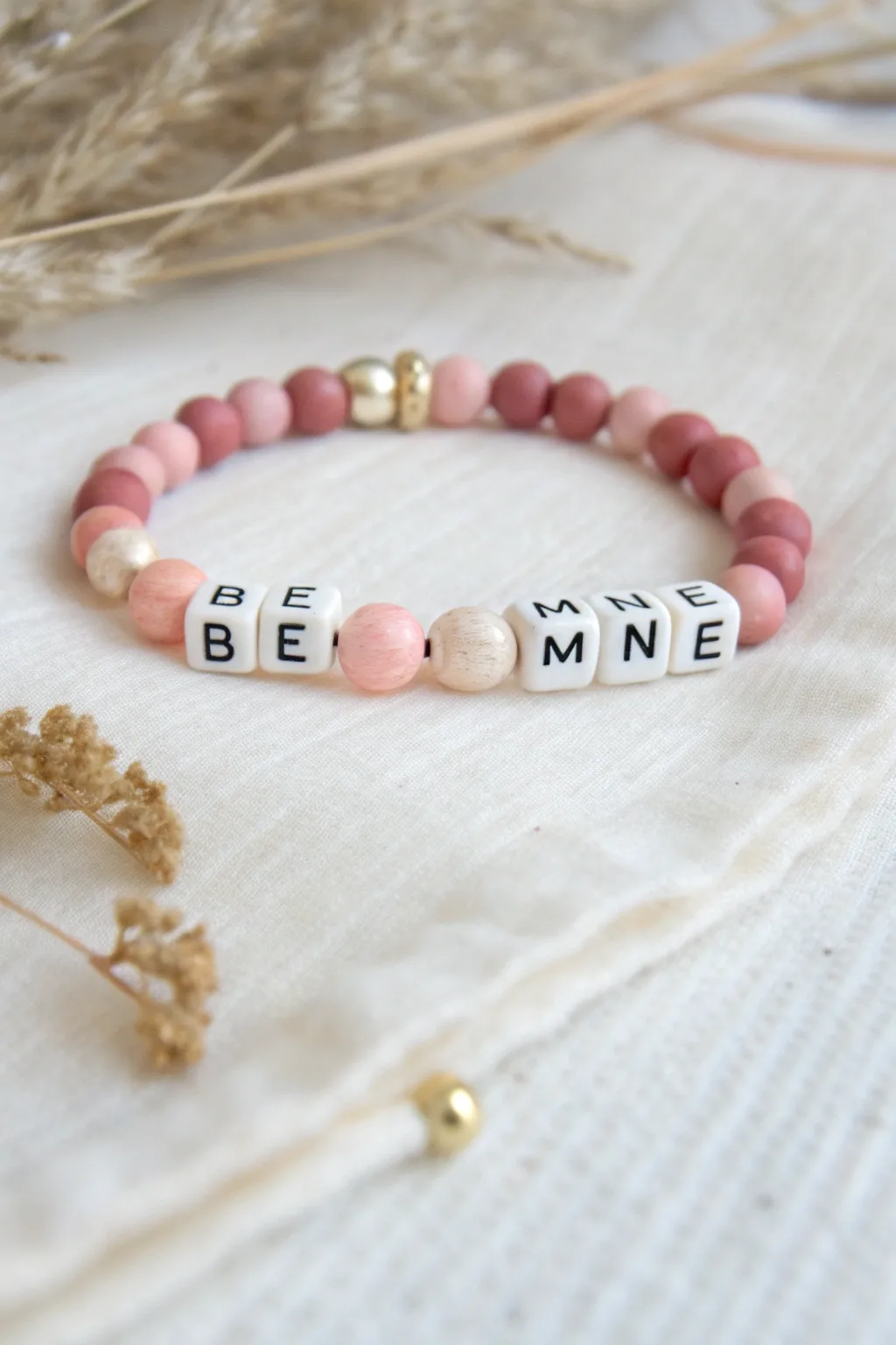 Soft pink clay bead bracelet with a gold spacer split-word design, sweet and minimalist.