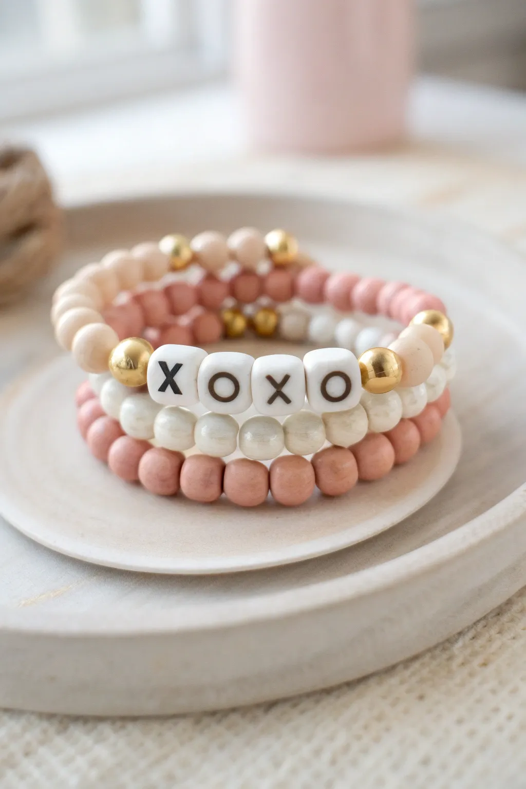 Pastel clay bead Valentine stack with XOXO centerpiece, minimalist Scandi boho mood.