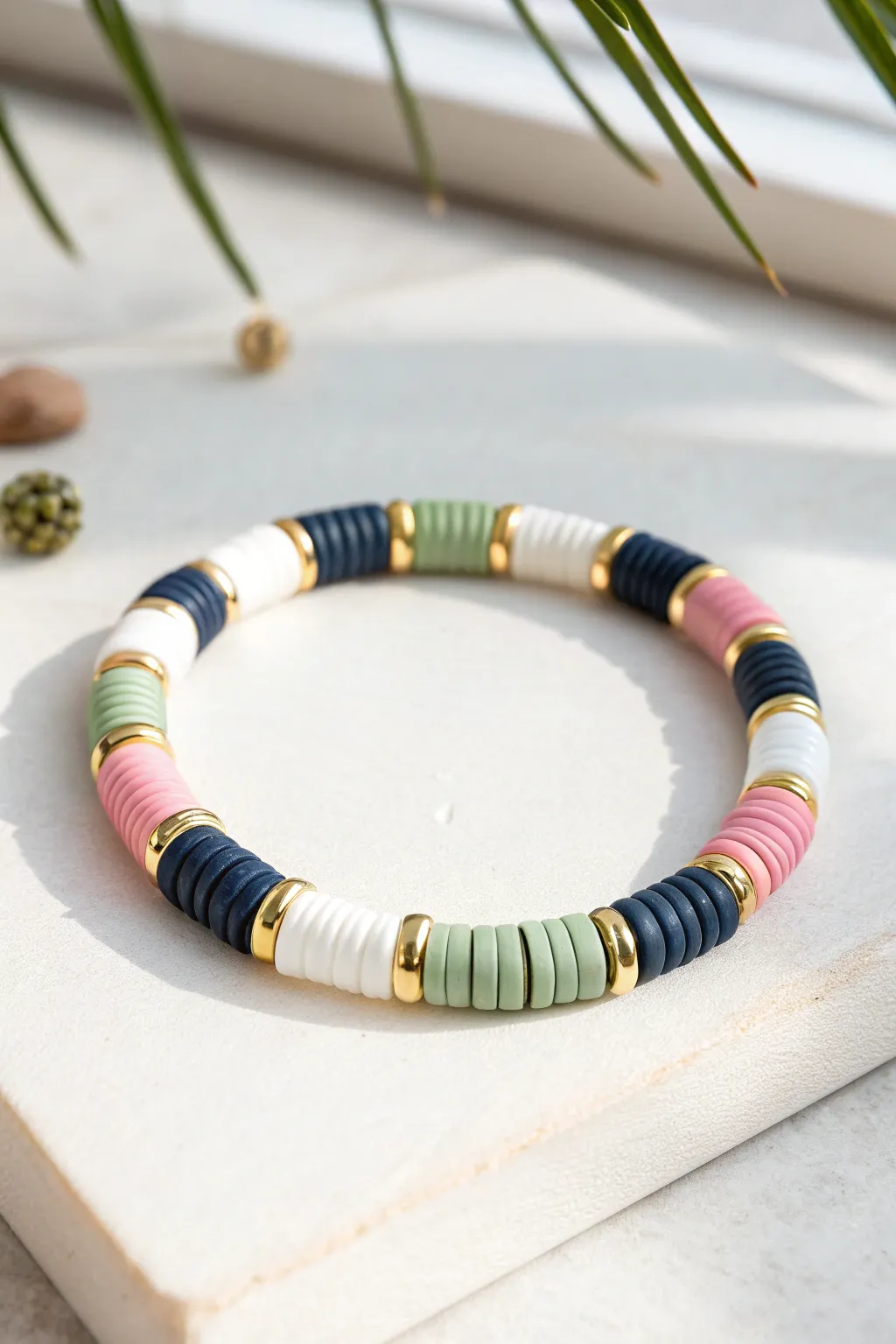 Bold color blocks and tiny metallic spacers make this preppy clay bead bracelet pop in a flat lay.