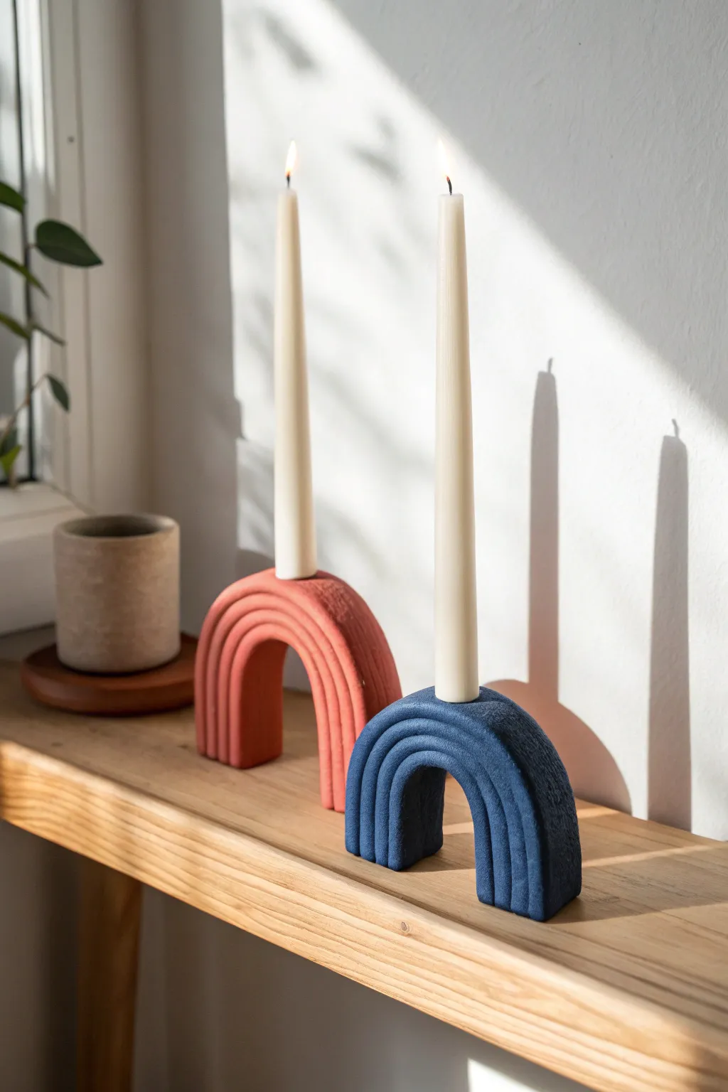Minimal arch air dry clay candle holders in bold color, clean lines, and warm natural light