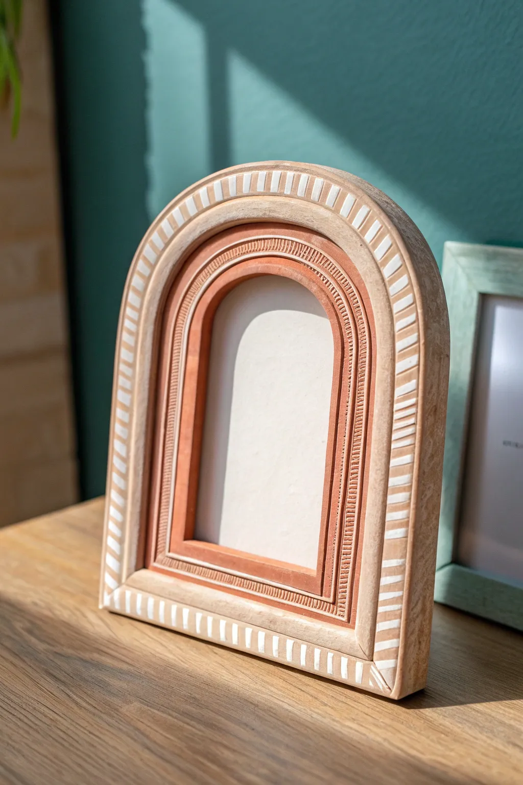 Modern boho arched air dry clay frame in warm terracotta with subtle carved lines and contrast