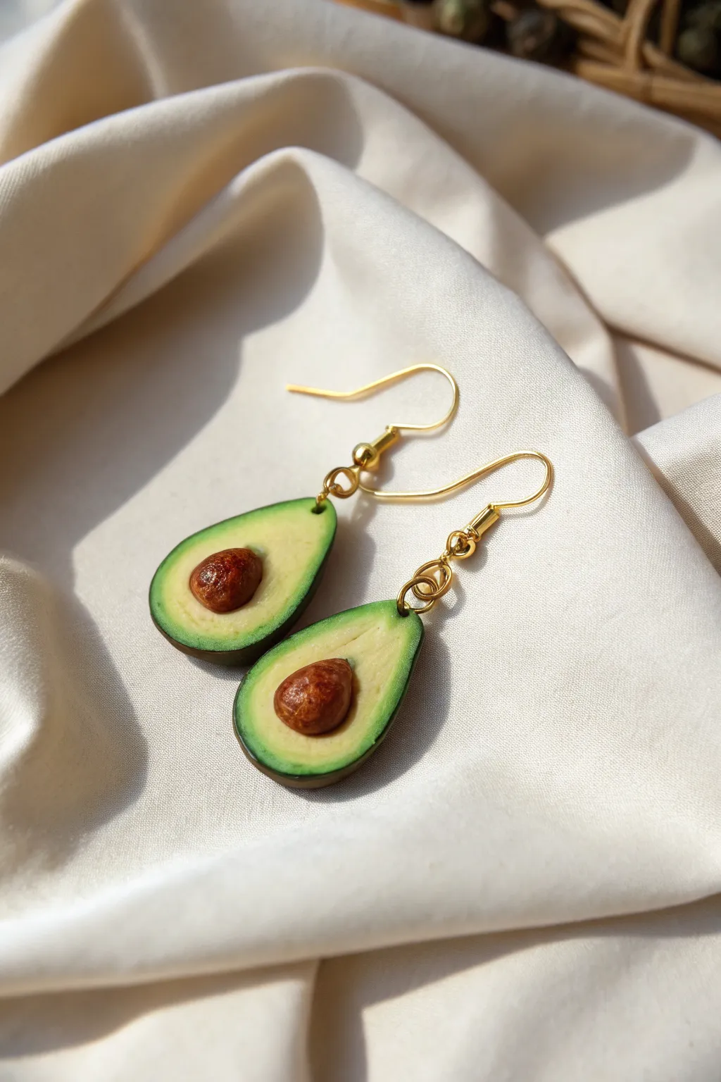 Mini avocado clay earrings in bold greens with tiny pits, minimalist and sweet for summer.