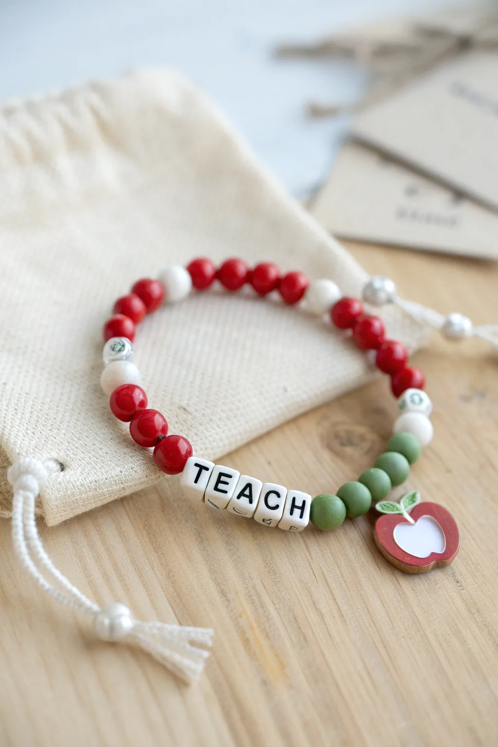 Apple-inspired clay bead bracelet, gift-ready for a favorite teacher in bold minimalist style