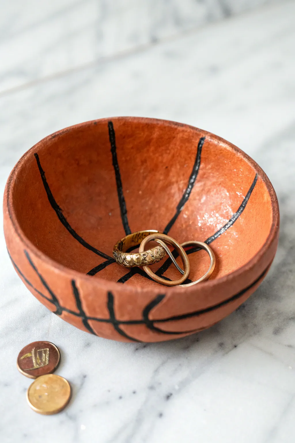 Handmade basketball pinch-dish catchall in bold orange, perfect for rings and loose change.