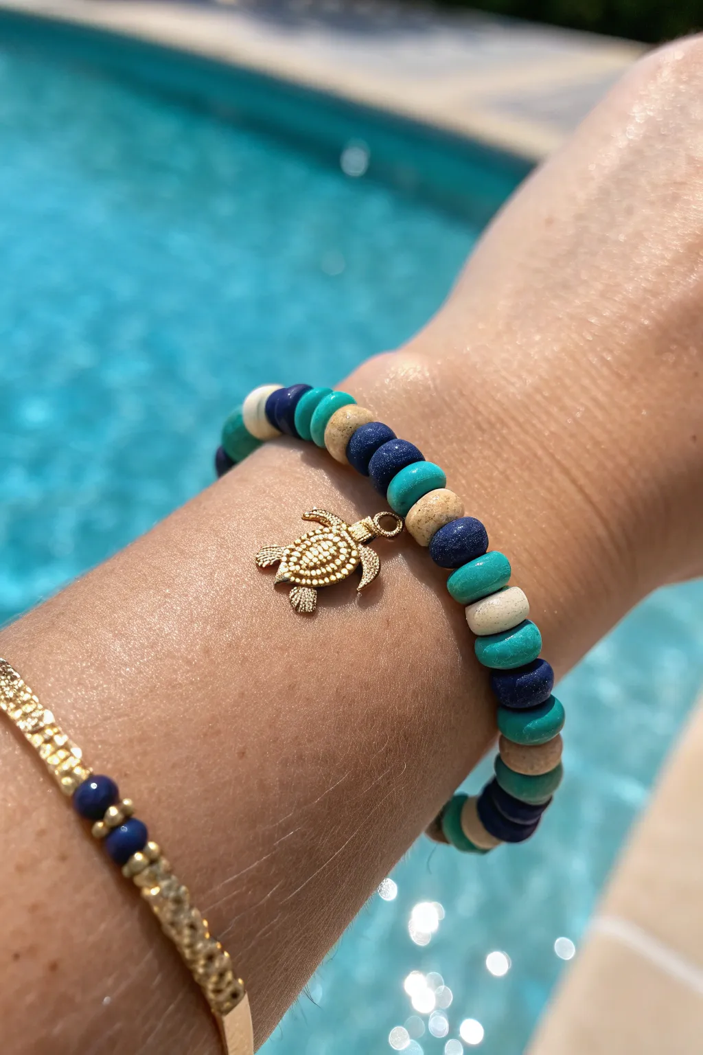 Ocean hues meet a tiny sea turtle charm for a simple beachy clay bead bracelet.