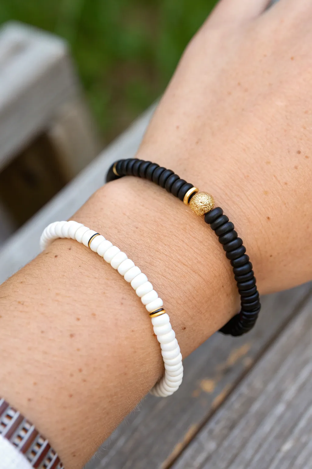 Half black, half white heishi bracelet with a bold split center for clean minimalist contrast.