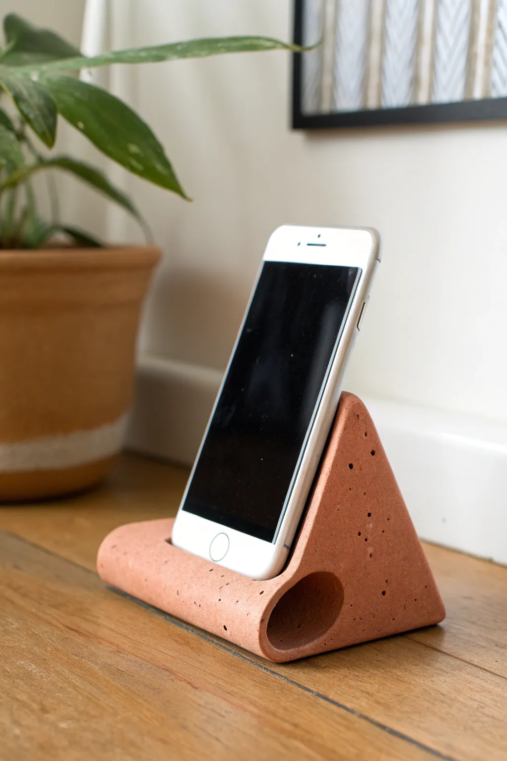 Chunky matte ceramic phone stand with a hidden sound chamber for natural audio boost