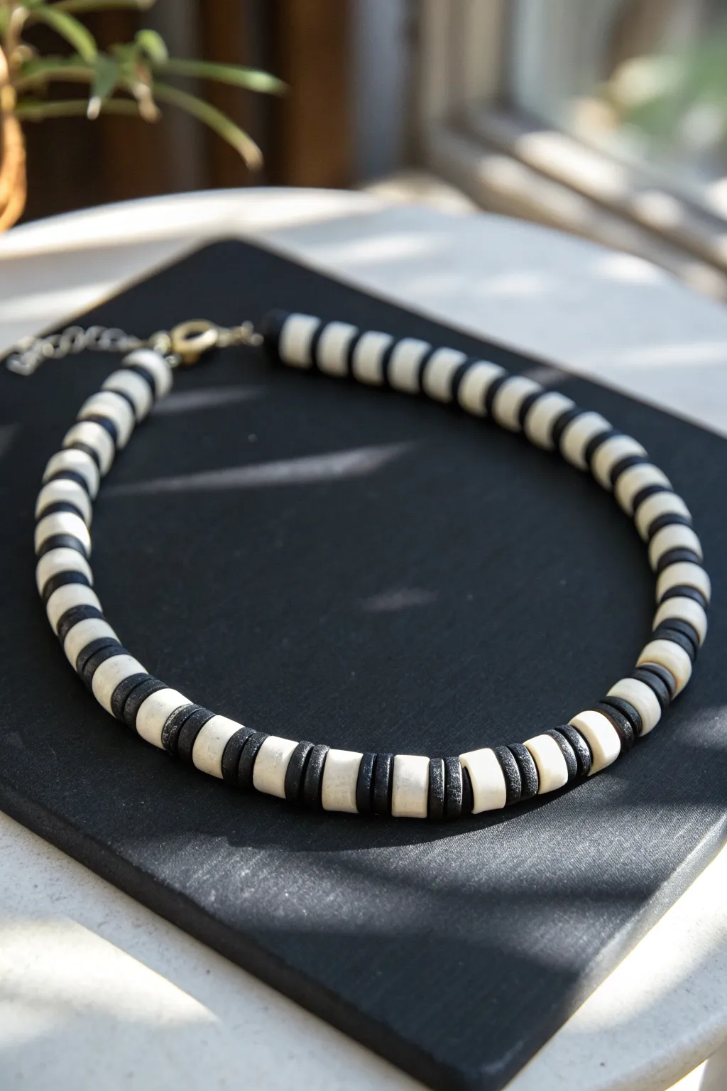Bold black and white clay bead choker with crisp pattern, minimalist and handmade statement.