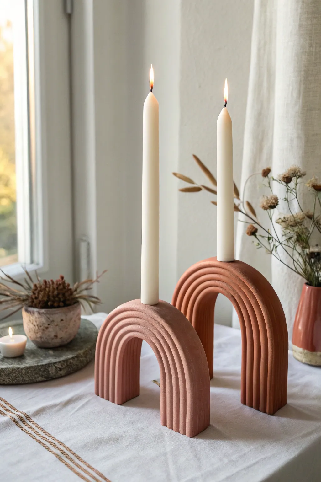 Chunky arch candle holders in warm earthy pastels, a modern minimalist statement for your table.