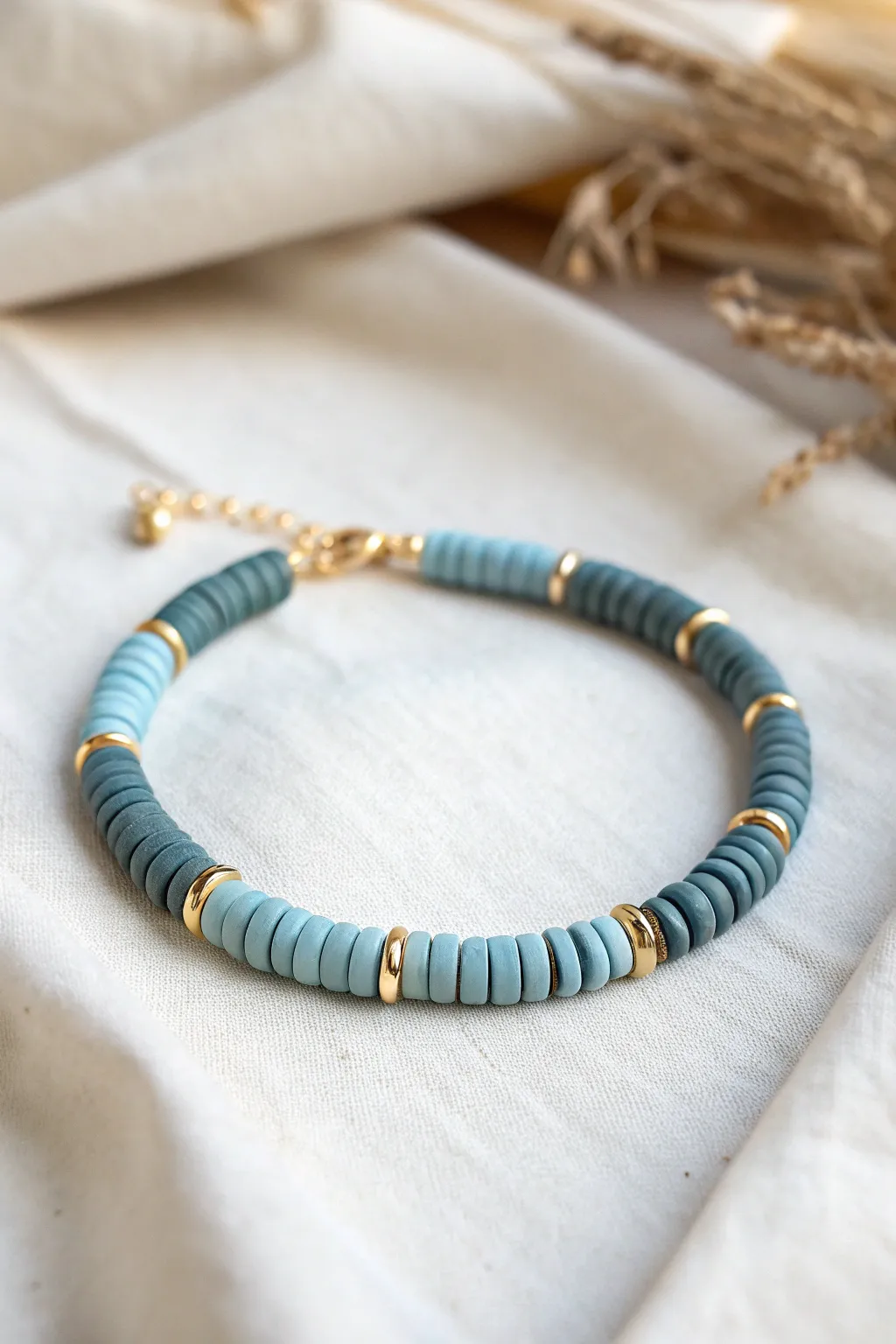 Monochrome blue heishi bracelet on linen, minimal and bold with handcrafted texture