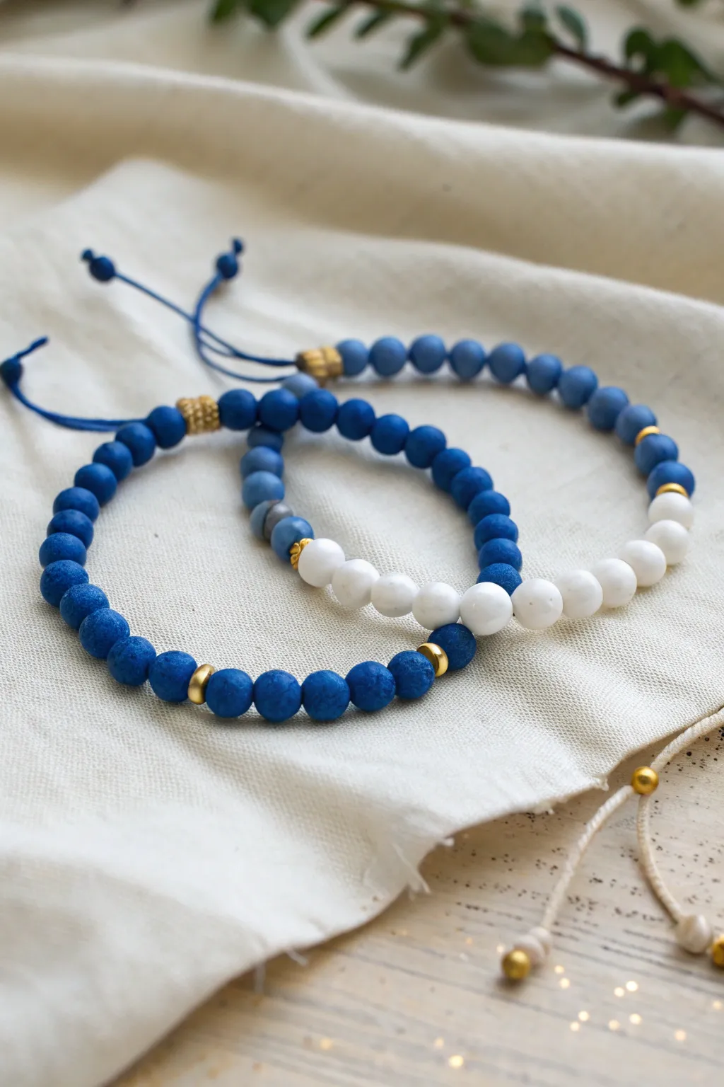 Two best friend clay bead bracelets with inverted blue and white palettes, simple and striking.