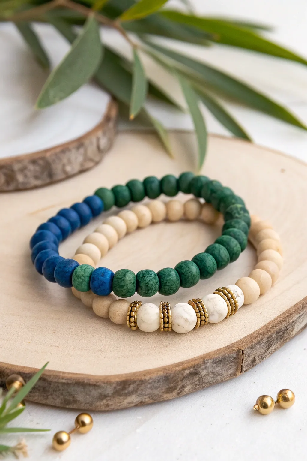 Couple bracelets in birth month colors, tied together with a calm neutral clay bead base.