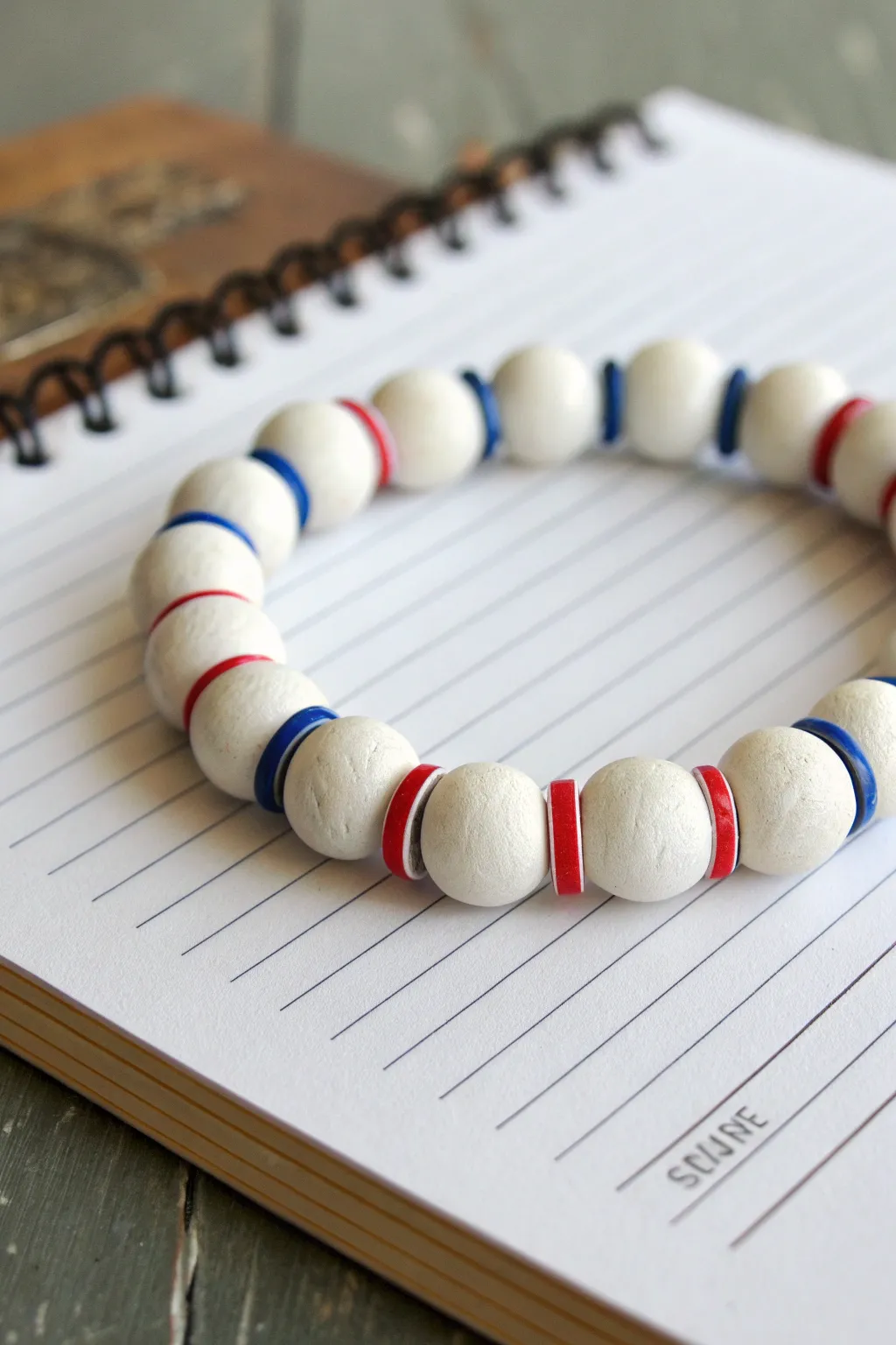 Lined notebook inspired clay bead bracelet for teachers, minimal, crisp stripes and bold accents.
