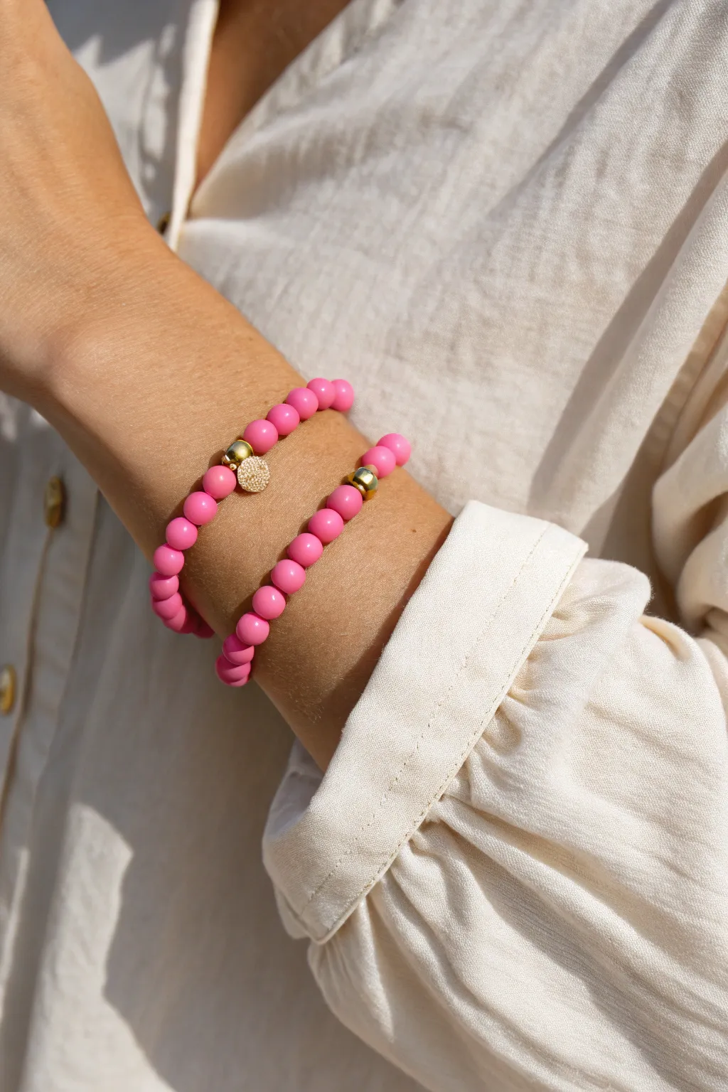 Hot pink clay bead bracelet with tiny gold accents, styled simply for a bold minimalist pop.