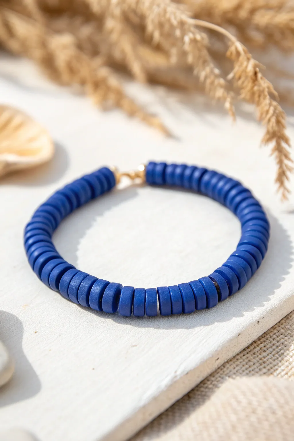 All-one-color minimal stack: matte cobalt heishi clay beads for a clean, modern look