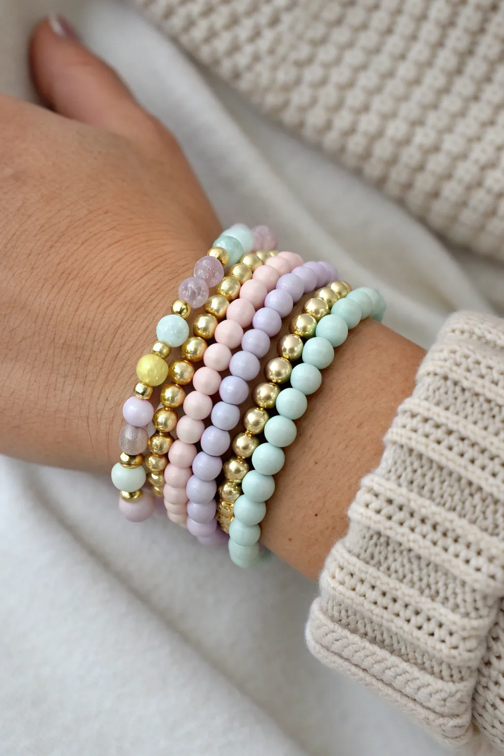Pastel clay bead stack with shiny metal spacers for a cozy minimalist boho vibe.