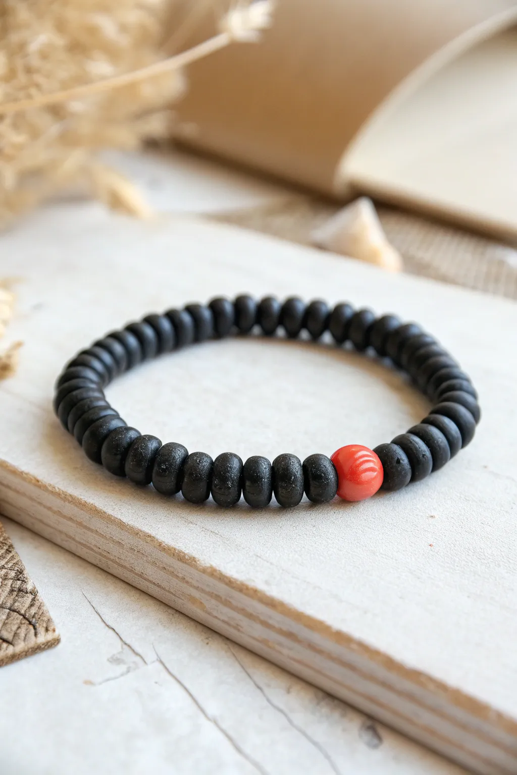 Monochrome heishi bracelet with a single pop bead for the cutest minimalist boho vibe.