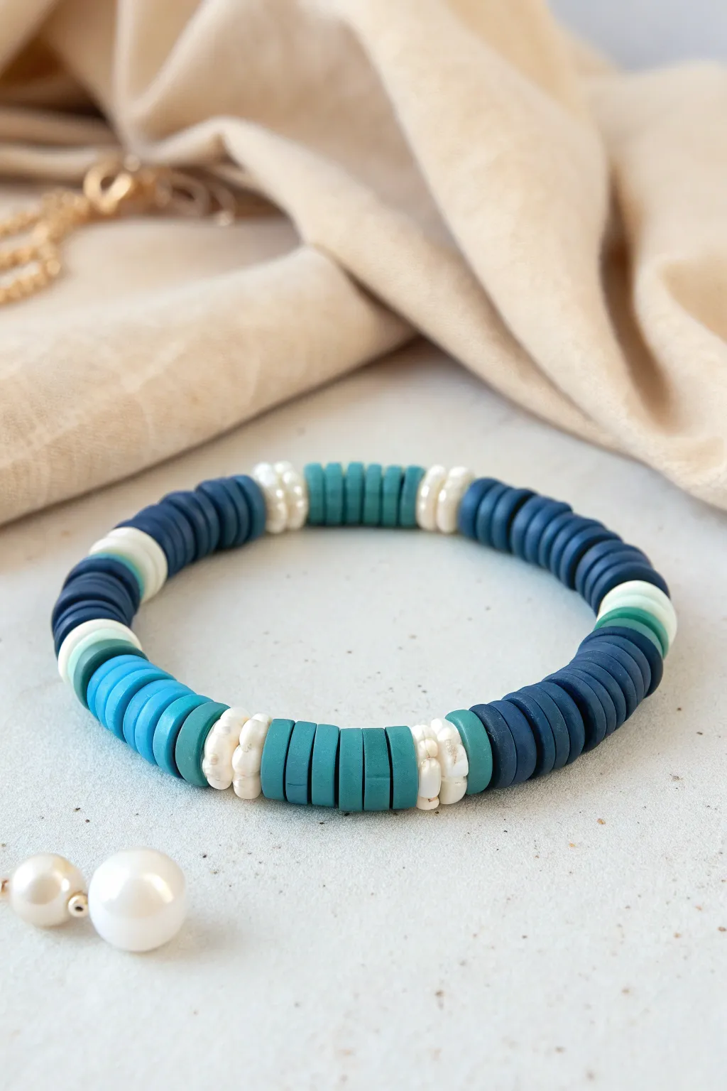 Ocean blue clay disc bead bracelet with pearl accents for an airy minimalist boho vibe