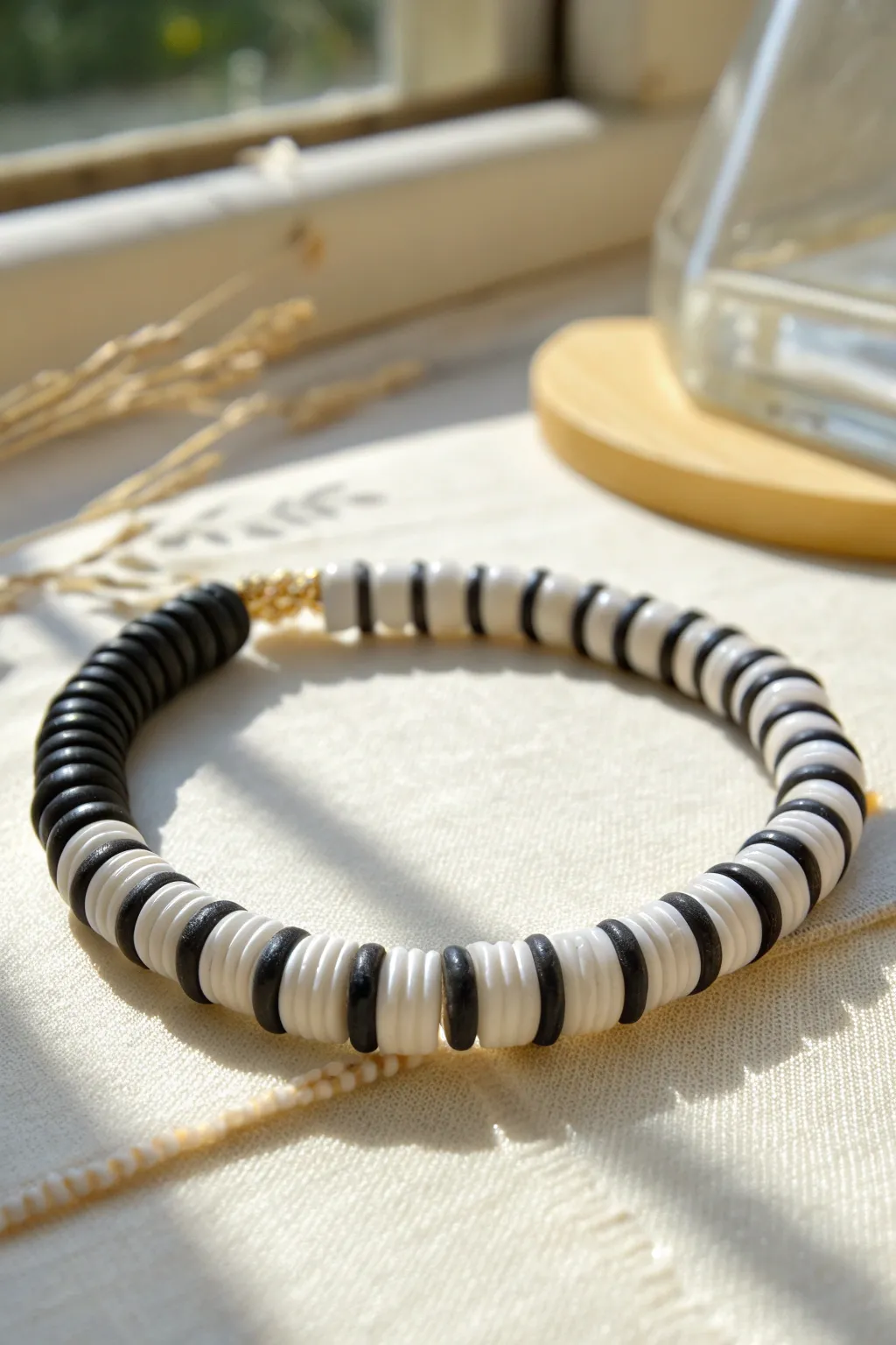 Bold black-and-white heishi stripes bring minimalist chic to an easy DIY clay bead bracelet.