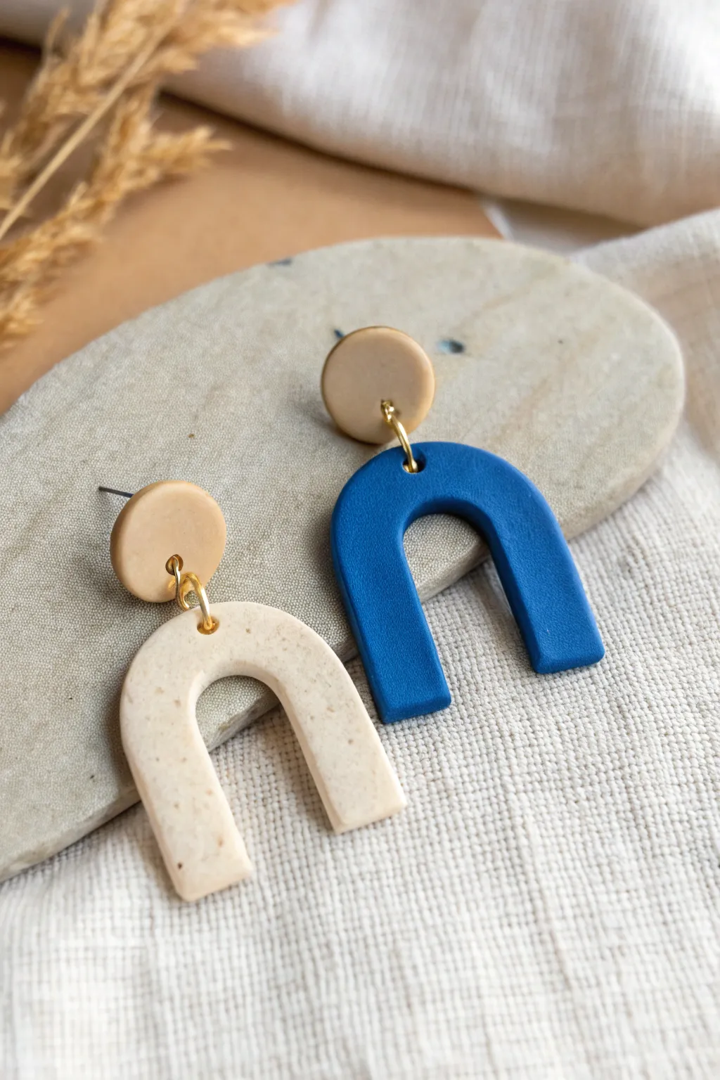 Beginner-friendly stacked clay earring: simple two-piece shapes with bold color contrast.