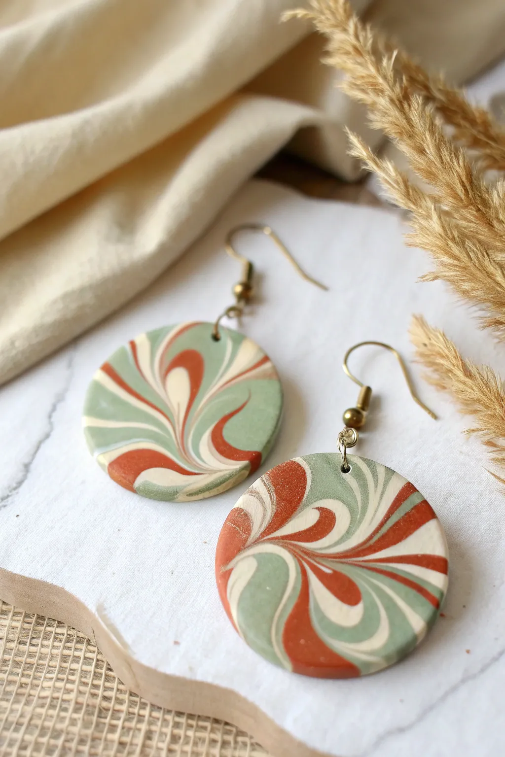 Marbled swirl polymer clay statement earring in sage, cream, and clay-red for bold minimal style