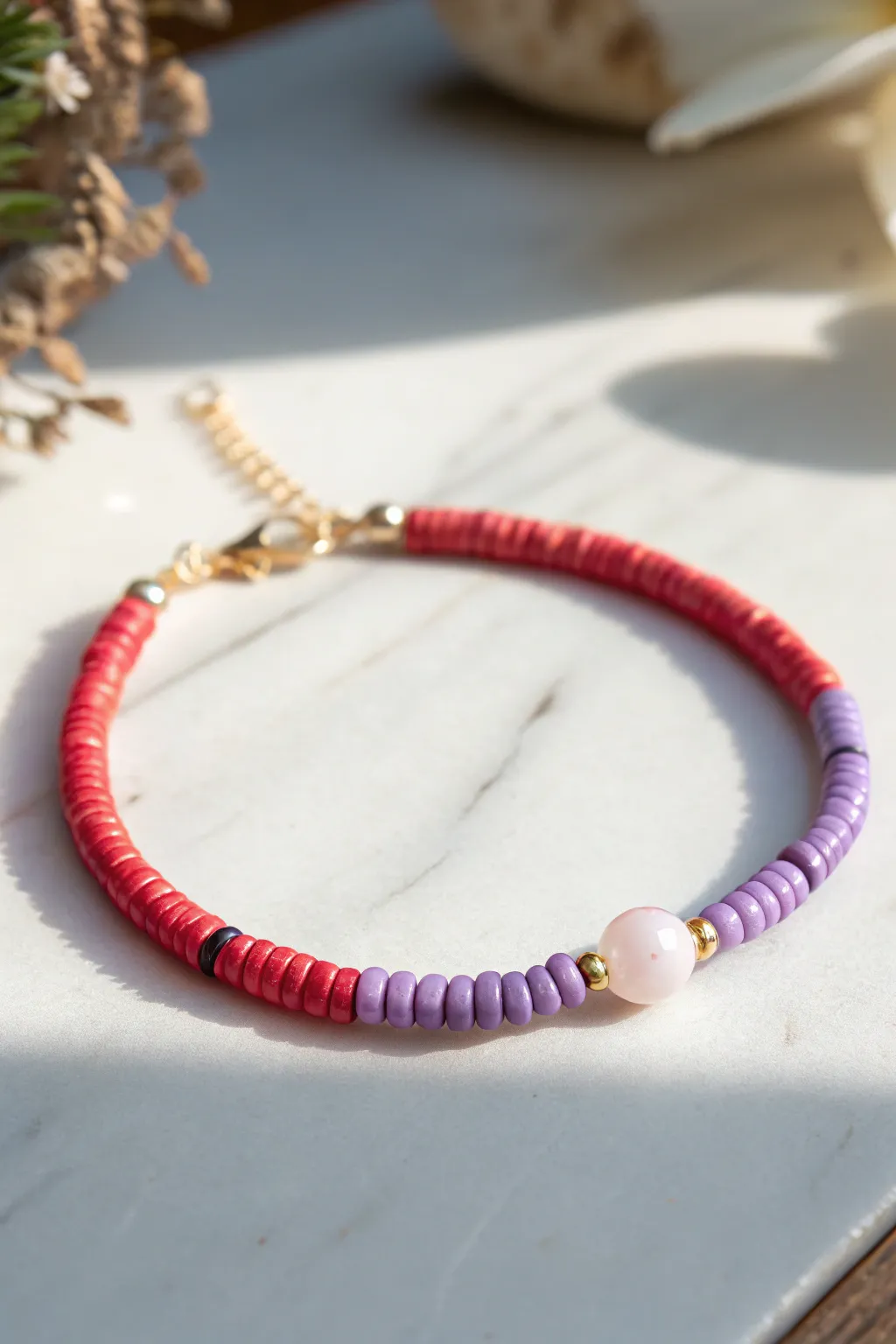 Rainbow heishi bracelet with a central focal bead for a clean, boho twist on color order.