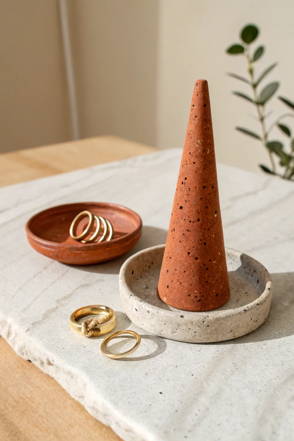 Minimal clay ring cone with matching dish, matte terracotta tones and clean Scandinavian contrast.